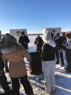 Large group photo showing adults receiving ice fishing education.