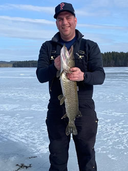 Man holding a Northern Pike he caught.