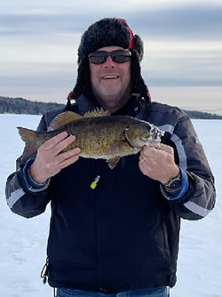 Smiling man holding a Smallmouth Bass.