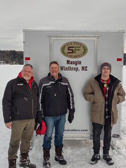 Group photo of three men during their ice fishing afternoon.