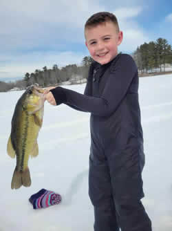 Boy holding a Largemouth Bass he caught.