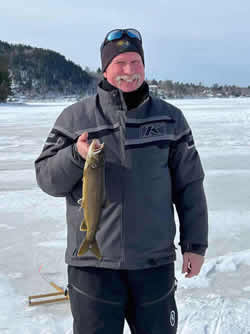 Smiling man holding a Lake Trout.