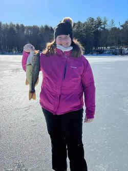 Smiling woman holding a Largemouth Bass.