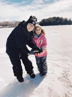 Mother and daughter holding a Chain Pickerel.