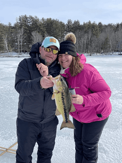 Couple holding a Largemouth Bass.