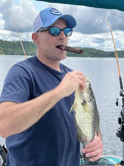 Man holding the Crappie he caught.