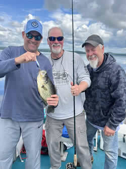 Three men with their open water fishing catch of Crappie.