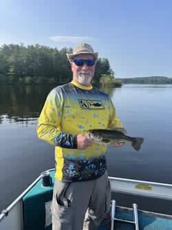 Man holding the Largemouth Bass he caught.