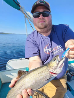 Man holding a Brook Trout he caught.