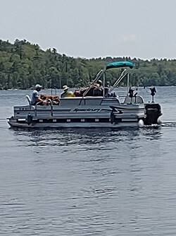 Fishing from a pontoon boat with Six Fins Guide Service.