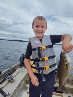 Smiling boy with Smallmouth Bass he caught.